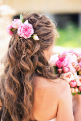 peonies in hair of the bride of pink color