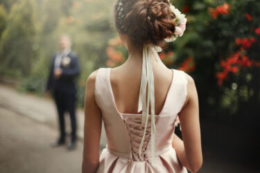 luxury bride looking at her groom walking, gorgeous pink and white bouquet, rich wedding couple, tender romantic moment at garden with blossoms